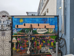 Bike rack installed, on the fence by the front gate